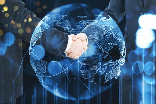 Two businessman shake hands at earth background