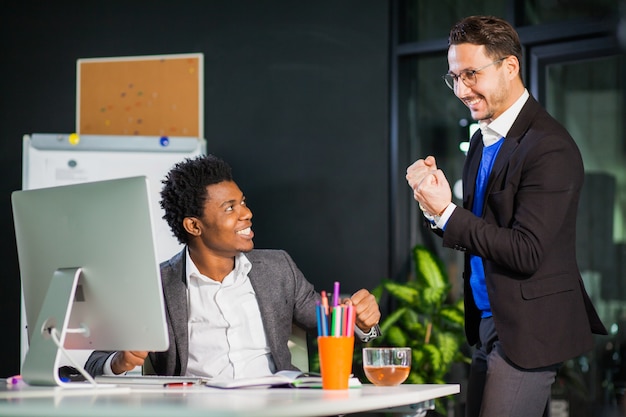 Two businessmen celebrate victory, goal reach, high five