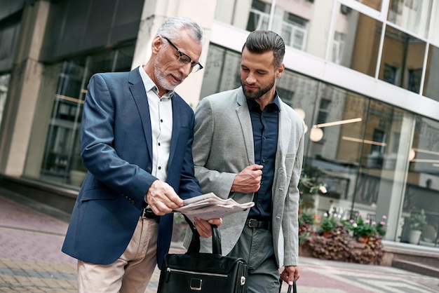 Two businessmen discussing about the new project while walking outdoors