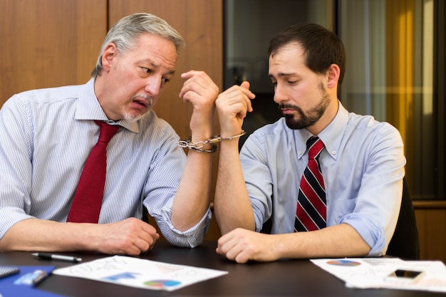 Two businessmen forced to work together bonded by handcuffs