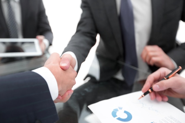 Two businessmen handshaking congratulating on promotion Close