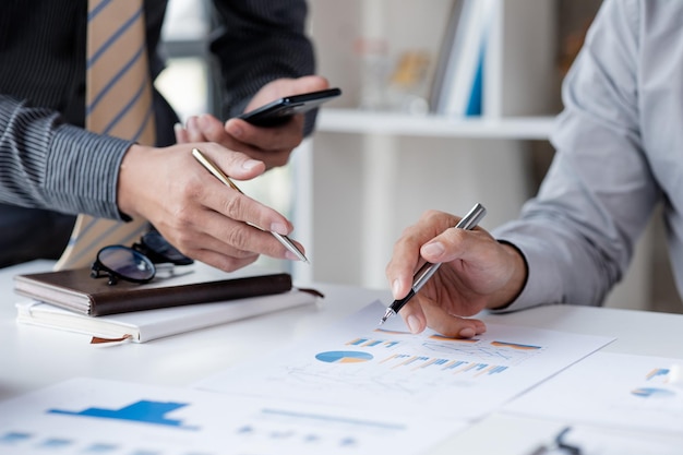 Two businessmen pointed to the material for the meeting working together to plan to develop and solve common business problems Concept of business management for growth and quality