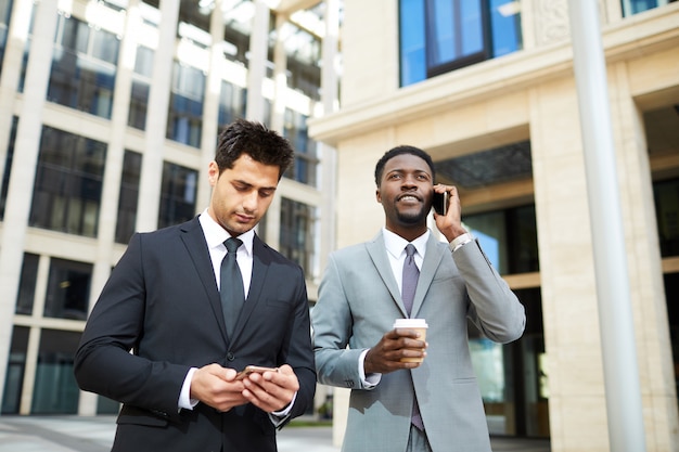 Two businessmenin the street in the city center