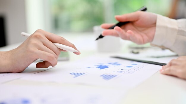 Two businesspeople discussing analyzing financial data and working on report in the office