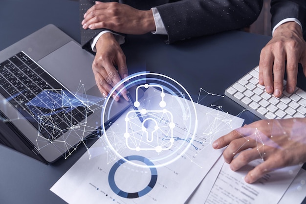 Two businesspeople man and woman working on the project to protect cyber security of international company Padlock Hologram icons over the table with documents Formal wear Workspace