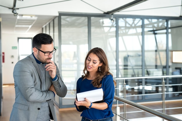 Two businesspeople sharing ideas and working together on a solution.