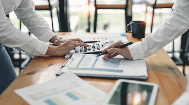 Two businesswoman working discussing business plan and strategy at office desk