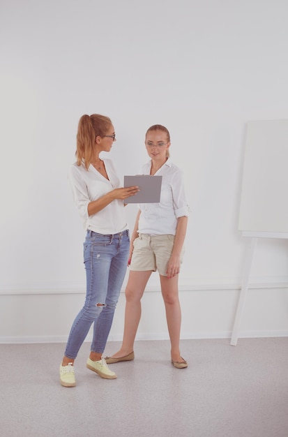 Two businesswomen having informal meeting in modern office