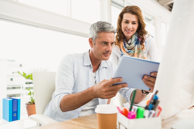 Two casual designers working with tablet