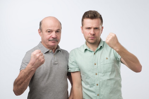 Two caucasian mature men ready to fight