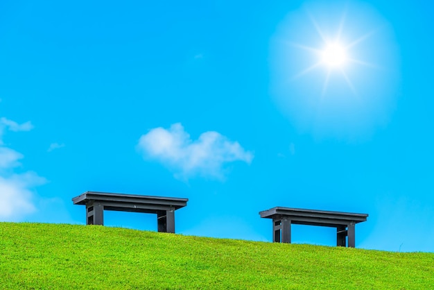 Two chairs empty on green grass at park in nature forest Mountain views spring bright blue sky weather nature abstract clear texture with white clouds summer light sun day