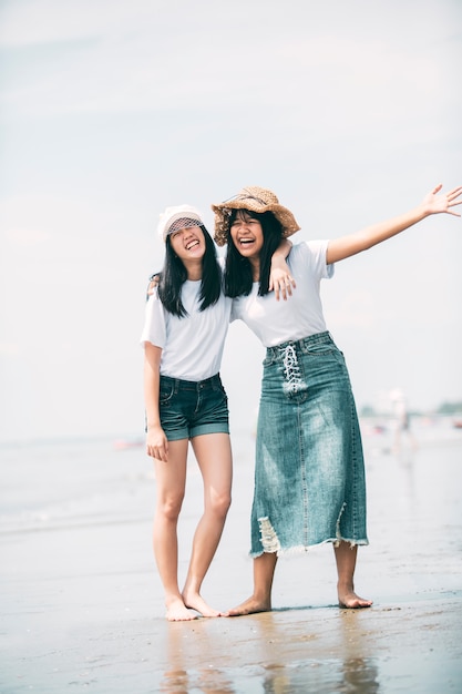 Two cheerful asian teenager happiness on vacation sea beach