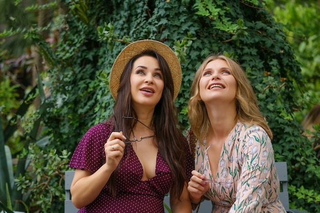 Two cheerful friends laughing in the street 