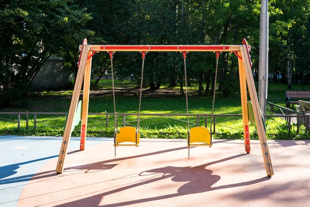 Two child swings in empty playground due coronavirus safety for children baby swings metal