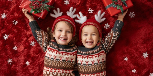 Two children in a deer hat and Christmas costume smiling