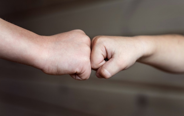 Two children's fists. Two children touch each other with their fists.