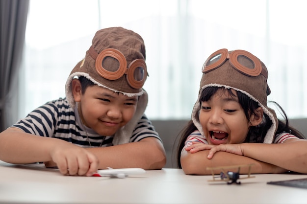 Two children with airplanes in hands