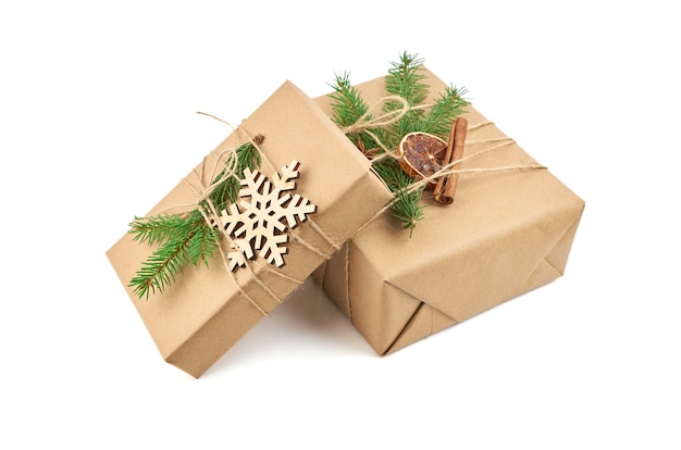 Two christmas gift boxes with fir tree branch and festive decorations