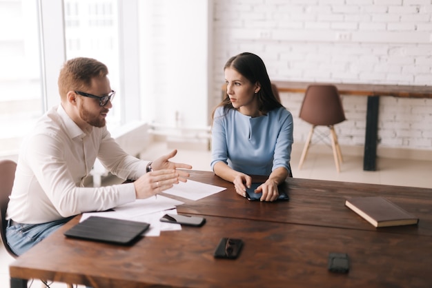 Two colleagues man and woman have business communication in the office