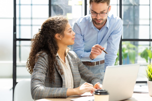 Two collegues discussing documents and other working moments in office