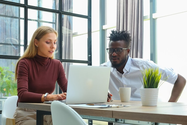 Two collegues discussing documents and other working moments in office