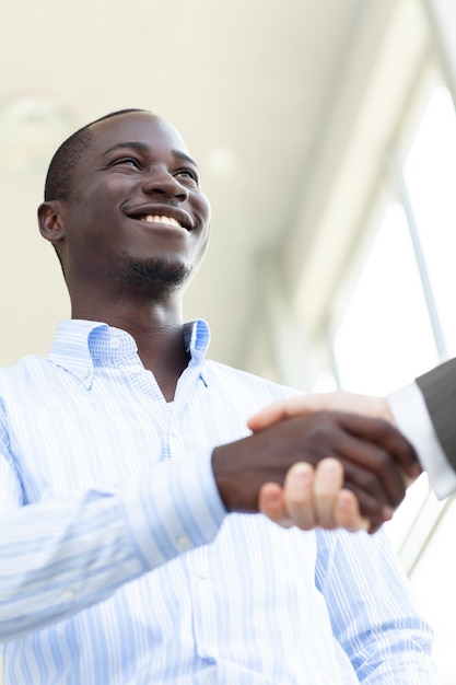 Two confident business man shaking hands during a meeting in the office success dealing greeting and partner concept