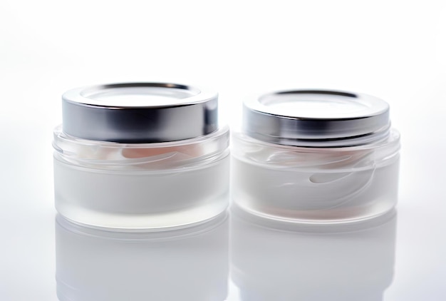 Two containers of moisturizing face cream on white background