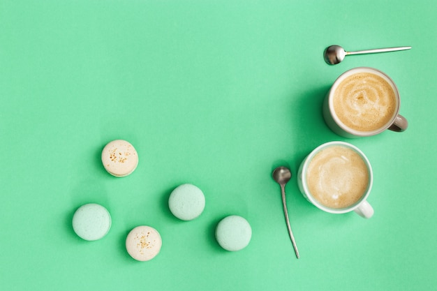 Two cup of coffee and tasty macarons