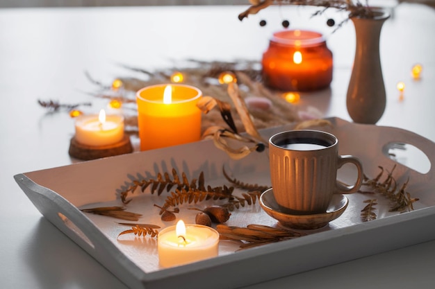 Two cups of coffee and autumn decor on white wooden tray