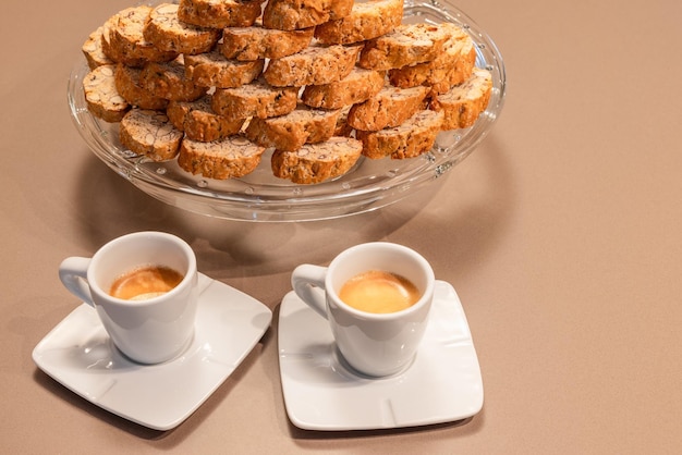 Two cups of Italian espresso coffee and traditional Italian almond cookies Cantucci