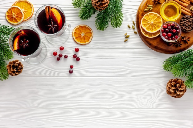 Two cups of mulled wine, spices and dry citrus fruits warming Christmas drink