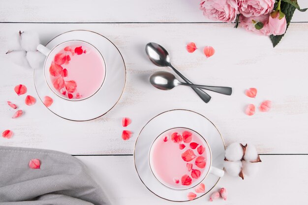 Two cups of pink matcha Trendy vegan tea on a white background Relaxing drink recipe for sleepy times