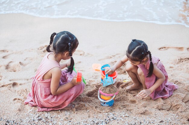 Two cute asian little child girls having fun to play 