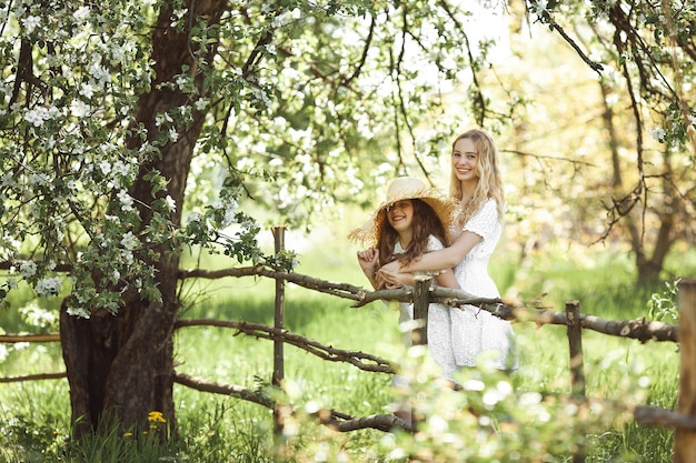 Two cute girls outdoor. Pretty sisters having fun together.