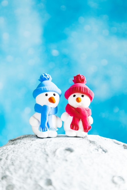 Two cute plasticine snowmen on the moon