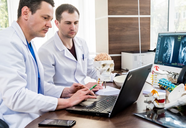 Two doctors having medical council in hospital.