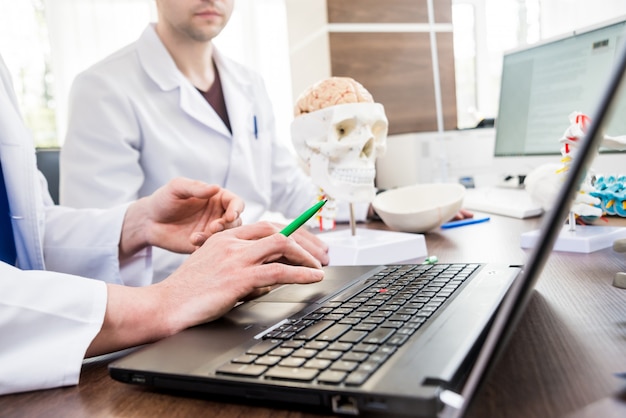 Two doctors having medical council in hospital.