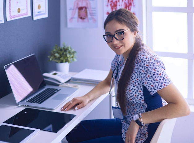 Two doctors speaking in a bright office