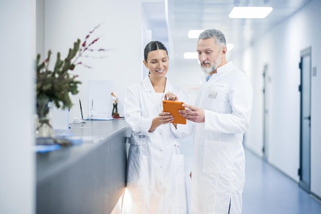 Two doctors talking in the hospital during the shift change