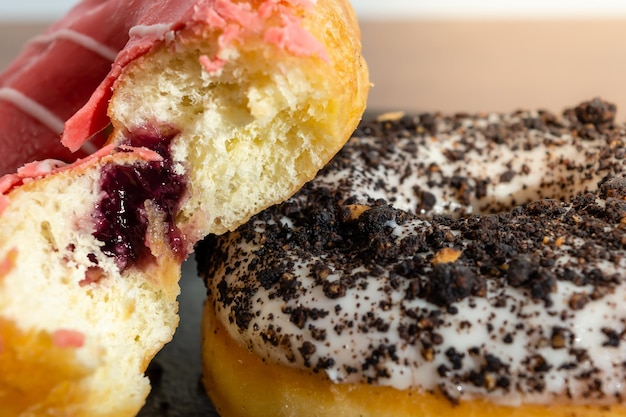 two donuts stacked over each other, made of red fruits and other of chocolate