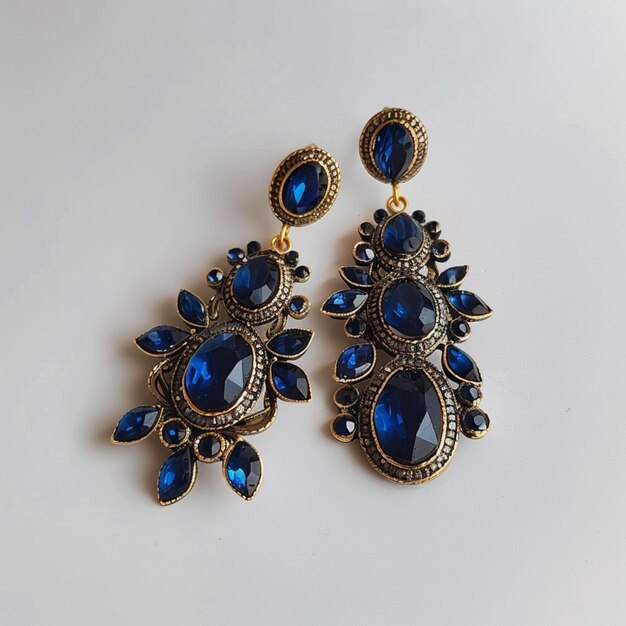 two earrings with blue stones and a gold flower