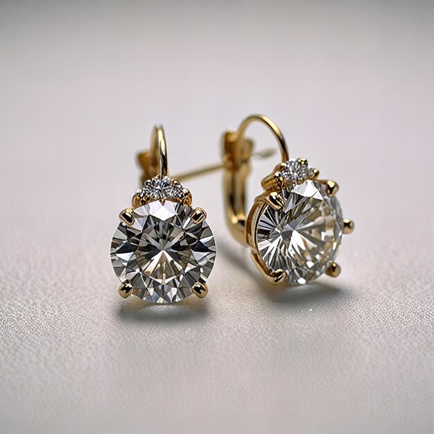 two earrings with diamond earrings on a white surface