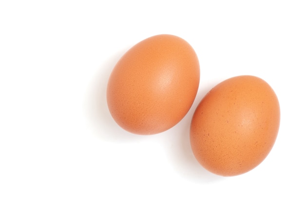 Two eggs are isolated on a white background. Top view.