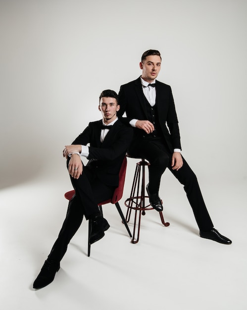 Two elegant men posing in studio