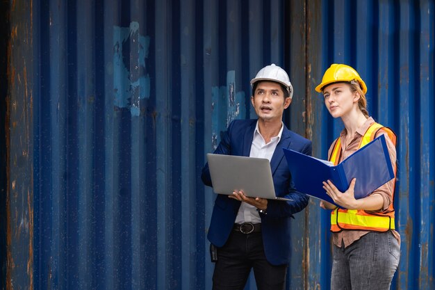 Two engineers checking the quality of containers box