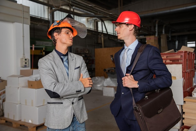 Two engineers at the construction site discuss the work to be done colleagues during work