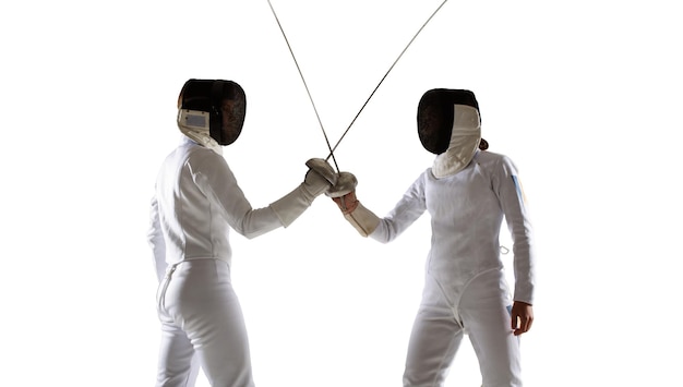 Photo two female fencing athletes fight isolated on white