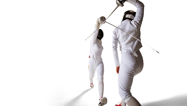 Photo two female fencing athletes fight in old fencing hall