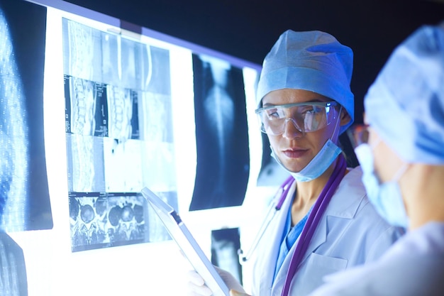 Two female women medical doctors looking at xrays in a hospital