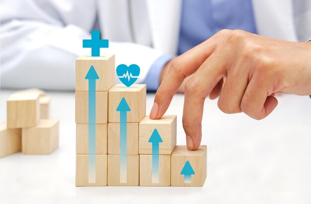 Photo two fingers of doctor is walking up stairs wooden blocks with medical symbol icons